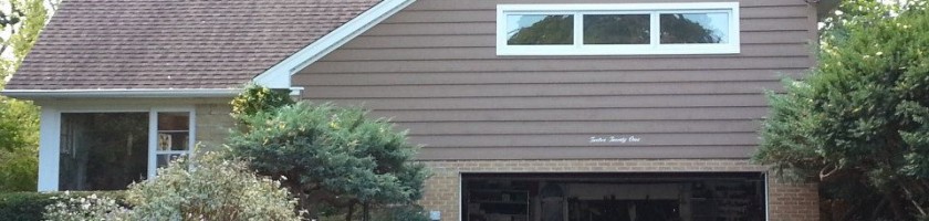 New Cedar siding, window trim, gutters, soffit, and fascia