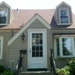 After Clay siding, gutters, and downspouts Almond gable and window trim