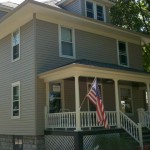 After photo taken in Lagrange Park Pebblestone Clay siding, gutters, and downspouts White soffit, fascia, and window trim