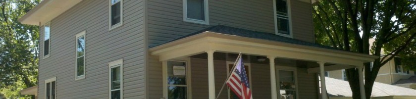 After photo taken in Lagrange Park Pebblestone Clay siding, gutters, and downspouts White soffit, fascia, and window trim