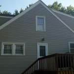 After Pebblestone Clay siding Almond gable and window trim