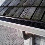 Seamless gutter with leaf protection. Also elbow and downspout coming from the middle