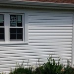 New siding, entry door, soffit and fascia, and garage window