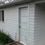 Old siding, soffit and fascia, entry door, and garage window
